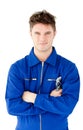 Charismatic mechanic holding tool and smiling