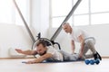 Charismatic physical therapist working out with handicapped in the gym Royalty Free Stock Photo