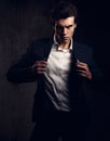 Charismatic male model posing and holding the fashion suit Royalty Free Stock Photo