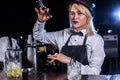 Focused girl bartender demonstrates his skills over the counter at the nightclub Royalty Free Stock Photo