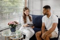 Charismatic woman doctor have a conversation with her patient man they discussing about his results on the x-ray while Royalty Free Stock Photo