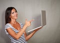 Charismatic woman pointing laptop while standing Royalty Free Stock Photo