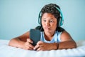 Charismatic young boy pulling a quirky face listening to music