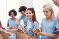 Volunteers packing food and drinks into paper bags Royalty Free Stock Photo