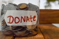 charity box written text of donate and jar in money and small hard,donate written text,wooden table on  donate box Royalty Free Stock Photo