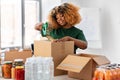 volunteer woman packing food in donation boxes