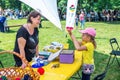 Charity Family festival: woman Ã¢â¬â volunteer and a girl at art and craft workshop