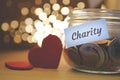 Charity money jar with blurred lights