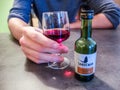 Close up of a man hand holding a glass of Sandeman porto Royalty Free Stock Photo