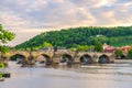 Charles Bridge Karluv Most with alley of dramatic baroque statues over Vltava river in Old Town of Prague