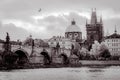Charles Bridge and Old Prague district with medieval churches and towers in Prague, Czech Republic, in black and white