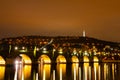 Charles Bridge in Old Town, Prague, Czech Republic at night. Lights. Petrin hill in the background.