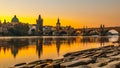 Charles Bridge with Old Town Bridge Tower reflected in Vltava River at morning sunrise time, Prague, Czech Republic Royalty Free Stock Photo