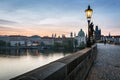 Charles Bridge at sunrise, Prague, Czech Republic. Dramatic statues and medieval towers. Royalty Free Stock Photo