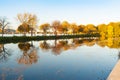 Charles River reflects autumn tones from trees with city buildings in view Royalty Free Stock Photo