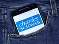 Charles Schwab logo on phone screen.