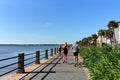 Charleston, South Carolina/USA - Sep 03, 2016: People running jogging on boardwalk with houses on one side and sea on the other