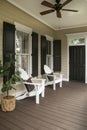 Charleston style porch with chairs and entry door on southern home Royalty Free Stock Photo