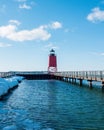 Charlevoix, MI /USA - March 3rd 2018: Charlevoix Michigans pier leading to its red lighthouse in winter