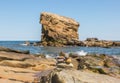 A sandstone sea stack off the coast of Seaton Sluice in Northumberland, England at high tide.