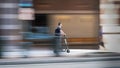 Charlotte, North Carolina, USA - August 24, 2021: Man with sunglasses rides scooter on sidewalk