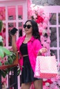 Women Asian cheerful pink shirt candid hand carrying debit card, smartphone and paperbag in cafe