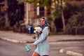 Charm of a woman adorned in an exquisite blue traditional dress, carrying a blue handbag and a bouquet of flowers