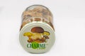 Charme canned mushrooms in a glass jar closeup against white
