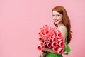 Charmful woman holding pink tulips