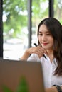 Charming Asian businesswoman or female college student using laptop Royalty Free Stock Photo