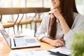 Charming asian businesswoman hand on chin, gazing out the window with inspired expression Royalty Free Stock Photo