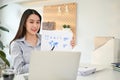 Charming Asian businesswoman having an online meeting with her marketing team Royalty Free Stock Photo