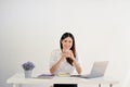 Charming Asian businesswoman sits at her desk. isolated white studio background Royalty Free Stock Photo