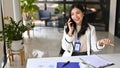 Charming Asian businesswoman talking on the phone with her business client Royalty Free Stock Photo