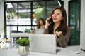 Charming Asian businesswoman talking on the phone with her client in the office Royalty Free Stock Photo