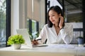 Charming Asian businesswoman using laptop, working on her business project in the office Royalty Free Stock Photo