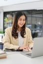 Charming Asian businesswoman working in the office, using laptop Royalty Free Stock Photo