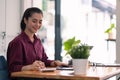 Charming asian female accountant or banker making calculations. Savings, finances and economy concept through a digital Royalty Free Stock Photo