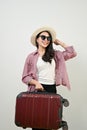 Charming Asian female tourist holding her luggage. isolated background. vacation, ourney, traveling Royalty Free Stock Photo