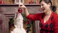 Charming asian girl plays cute funny bulldog. doggie is very cute playing with a Christmas toy. Christmas. New Year. The