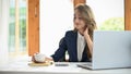 Charming Asian young businesswoman having coffee during working on her project Royalty Free Stock Photo