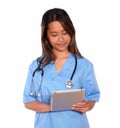 Charming asiatic nurse woman working on tablet pc Royalty Free Stock Photo