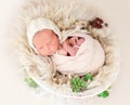 Charming awake newborn lying in cradle