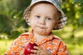 Charming babe in panama eating delicious apple