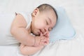 Charming baby boy sleeping on comfortable bed.Adorable asian newborn sucking thump.This is growth development behavior Royalty Free Stock Photo