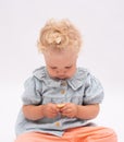 Charming baby girl holds a cookie