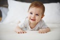 Charming baby lying on the bed