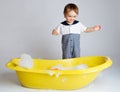 Charming baby standing near bathtub Royalty Free Stock Photo