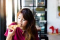 Charming beautiful asia woman enjoy eating yummy pizza and sticky mozzarella cheese. It has good taste. Pretty customer girl gets Royalty Free Stock Photo