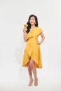 Charming beautiful woman with yellow luxury dress cheerful hand hold yellow wine glass drink in new year party festival concept